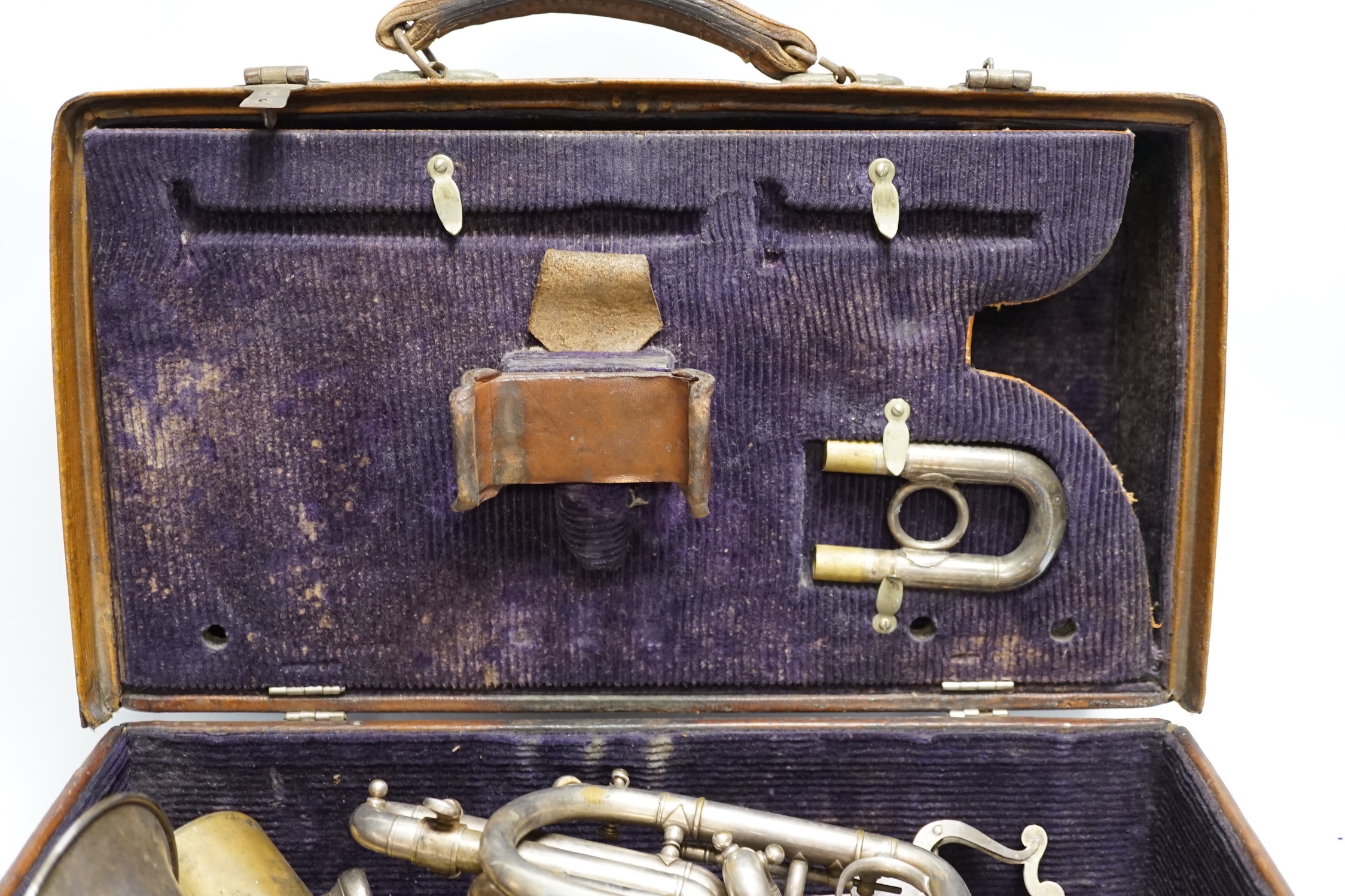 A cased Hawkes & Son cornet, bell engraved with ‘Excelsior Soncrous Class A’ and an ‘American Standard High Grade’ trumpet, with a brass mute and three mouthpieces